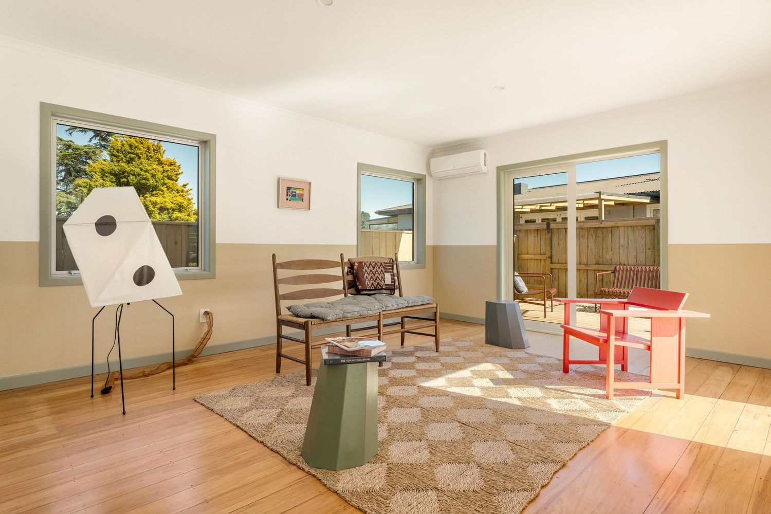 Real estate collage showing a bright beige carpeted bedroom with large windows and sunny views throughout.