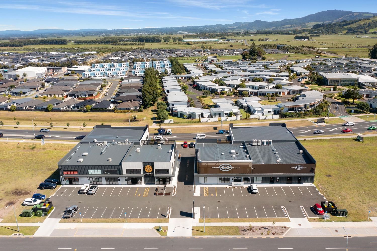 Bird's eye view of large industrial buildings and warehouses spread across a commercial district.