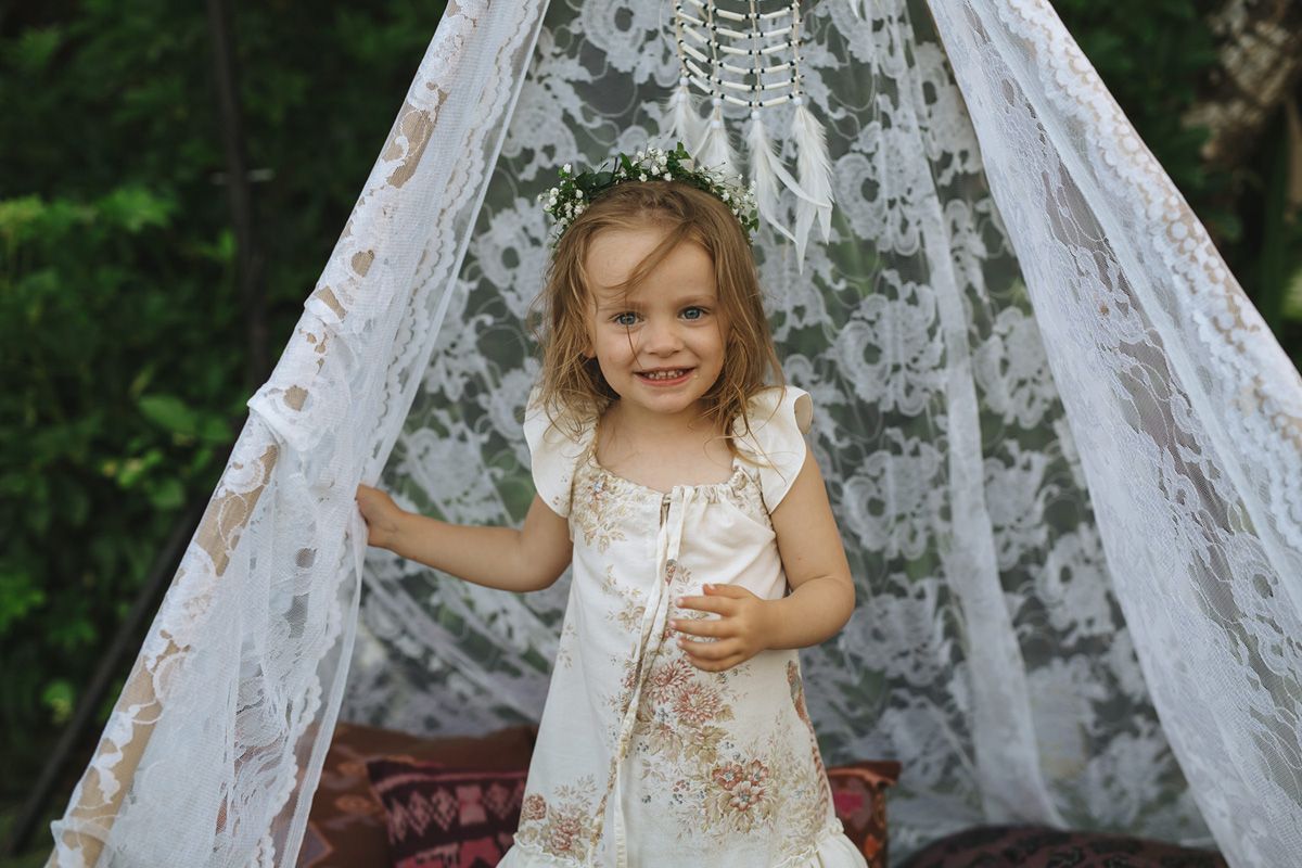 A series of outdoor portrait shots featuring a white lace backdrop with greenery in the background.