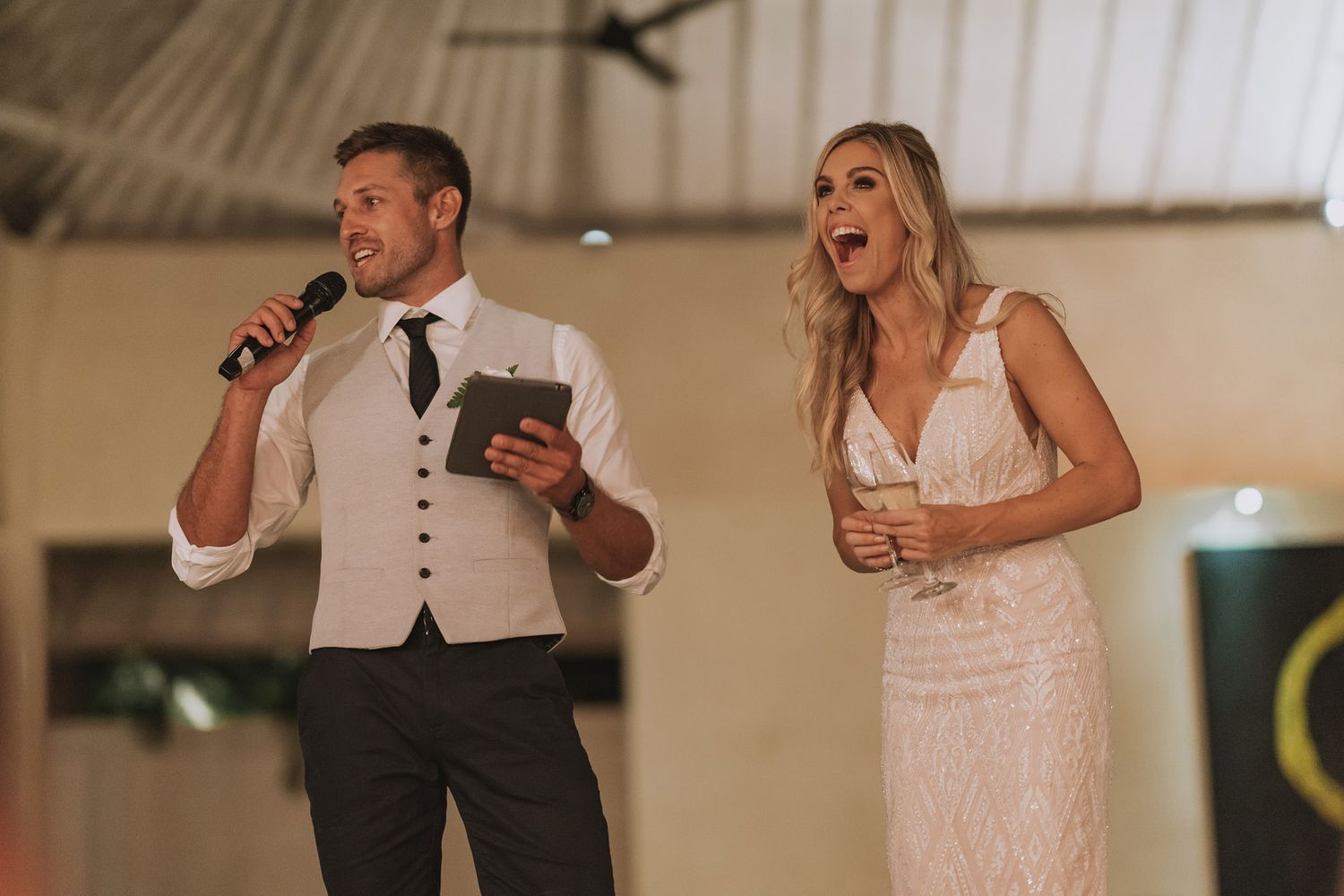 Wedding celebration inside a white-pillared venue with guests dancing and enjoying festivities.
