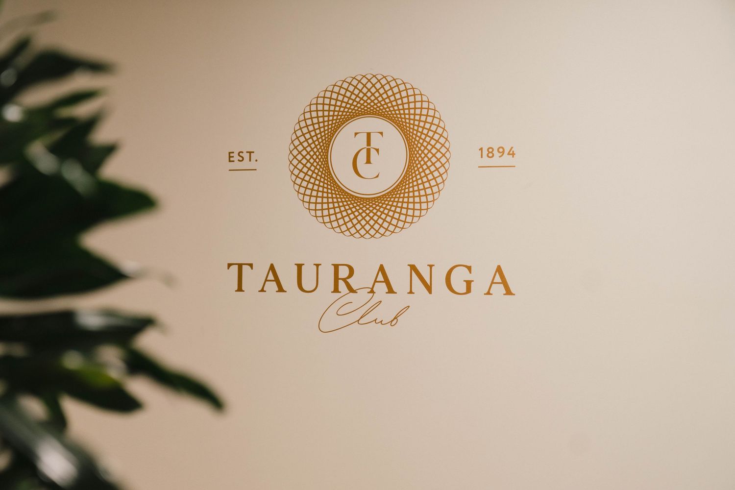Elegant golden circular logo design pattern with the text 