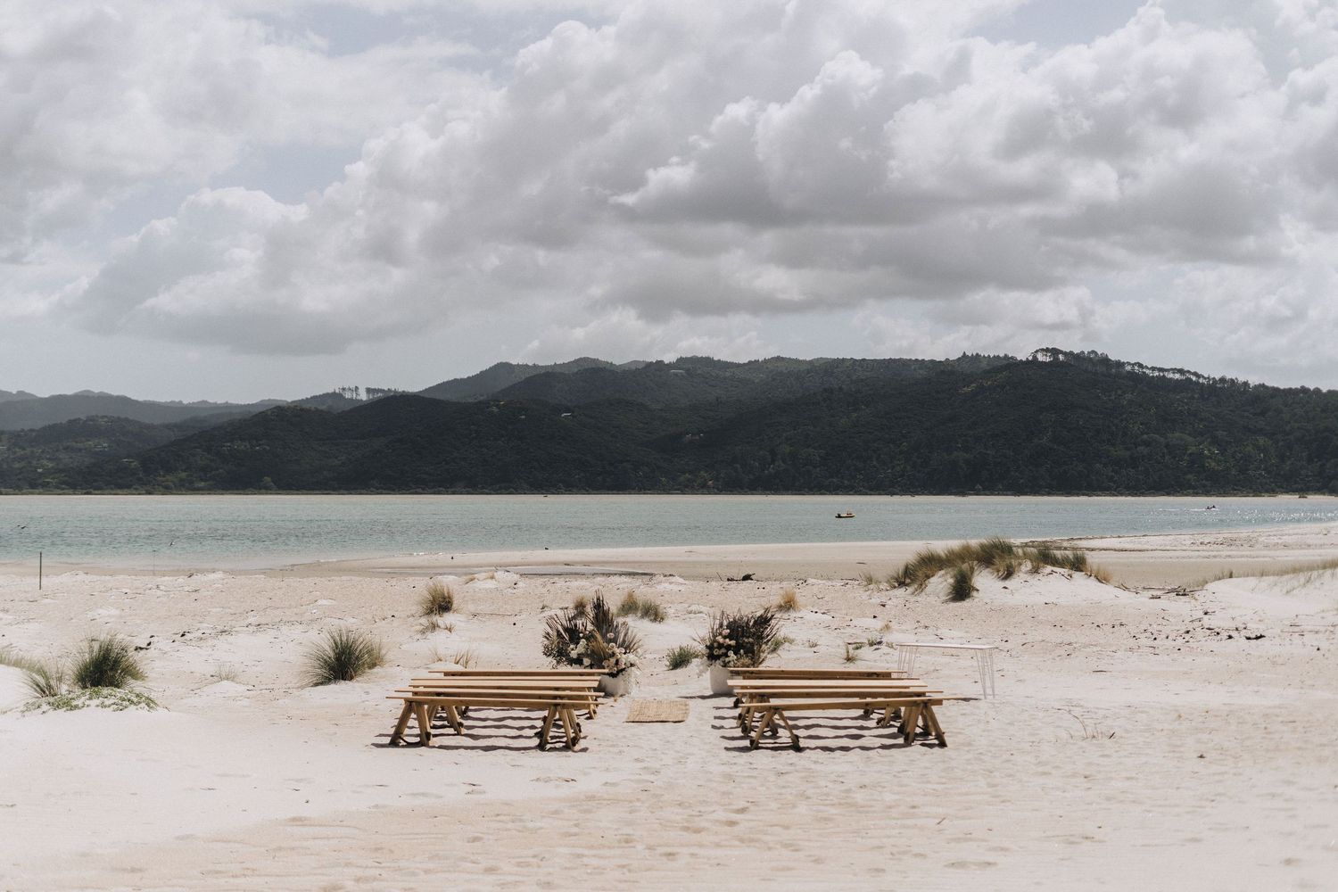 A collection of panoramic beach landscape photographs showing sandy shores, dunes, and coastal mountains under cloudy skies.