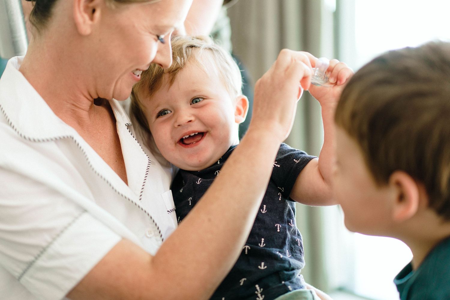 Joyful family moment captured indoors as loved ones share playful interaction and laughter together.