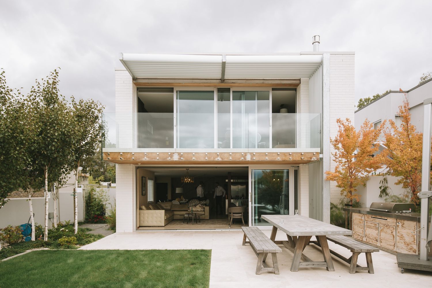 A modern white villa with large windows and a terrace showcases sleek minimalist architecture across multiple connected views.