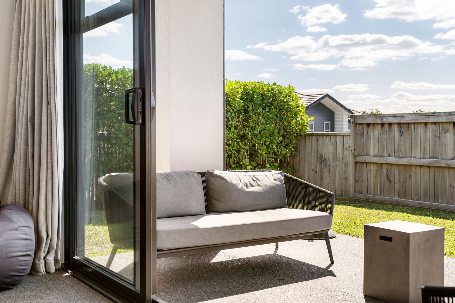 A series of sliding glass doors in a modern bedroom showcase scenic outdoor views and natural lighting.