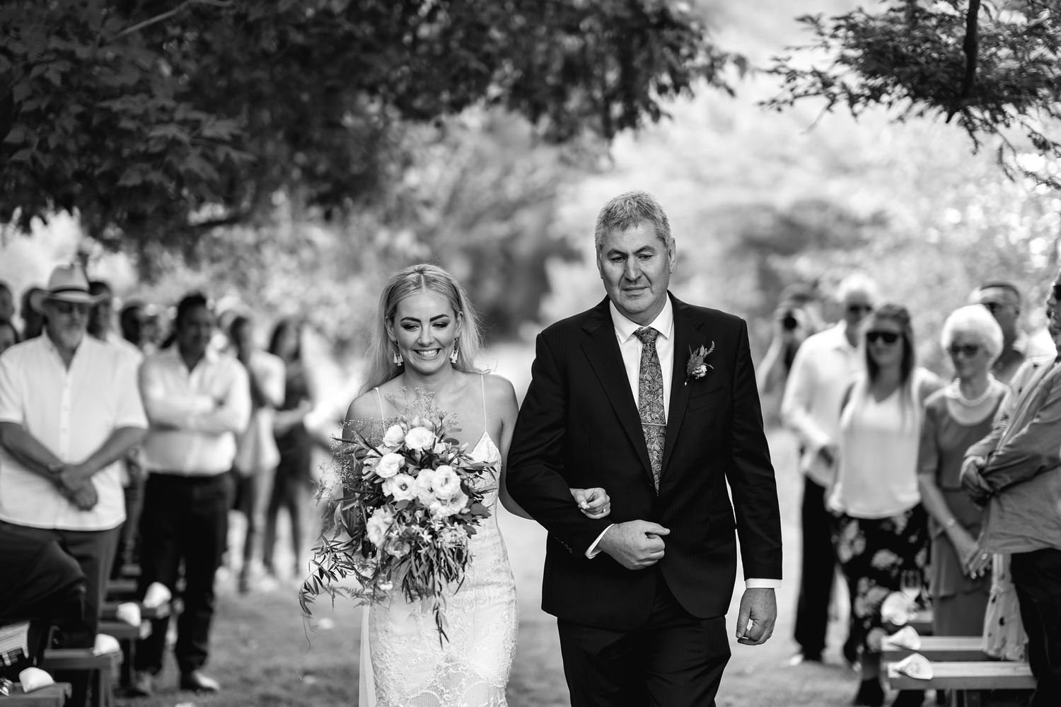 A black and white wedding photo collage showing different moments from the ceremony and reception.