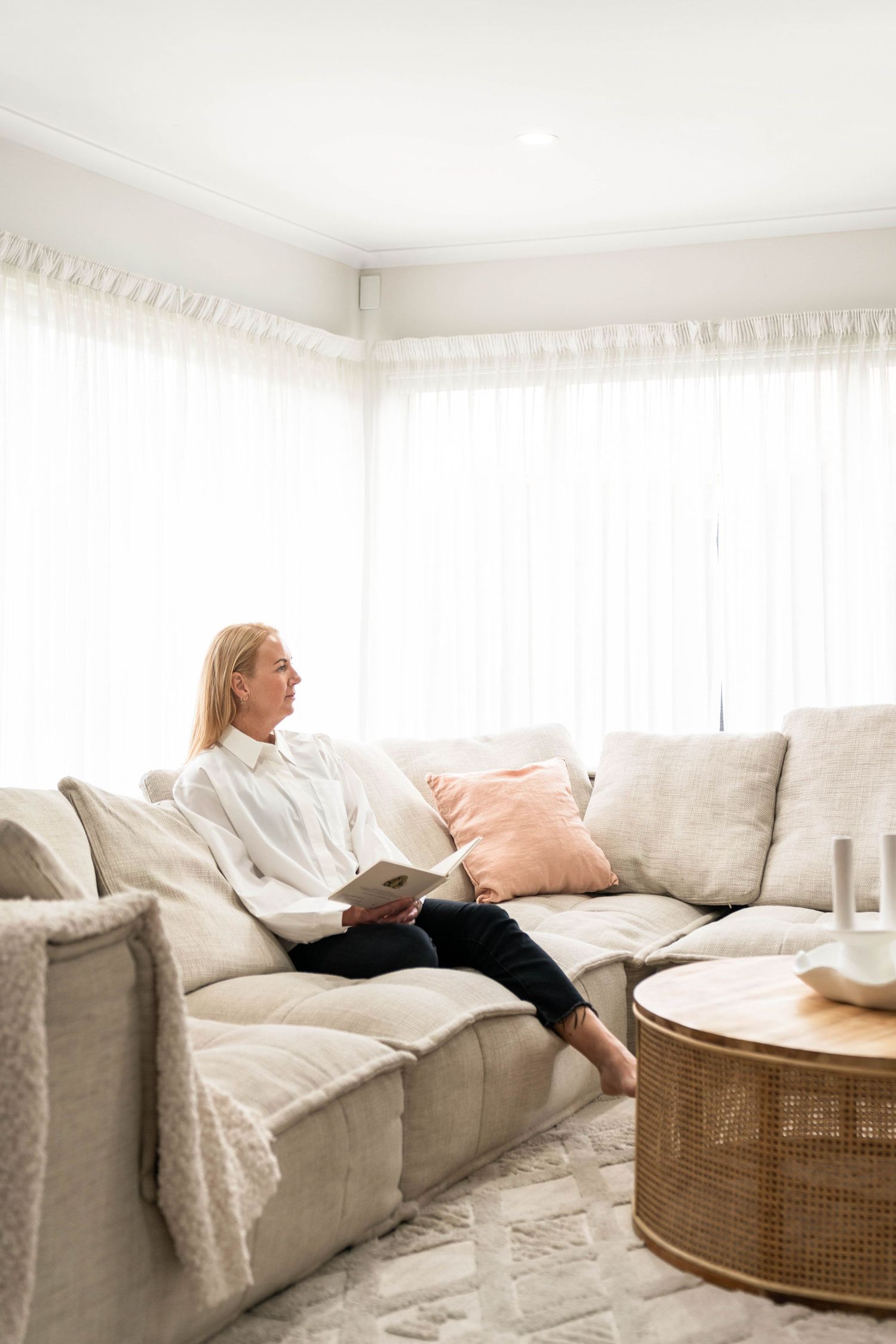 Scene of a bright living room with a comfortable gray sofa and modern decor.