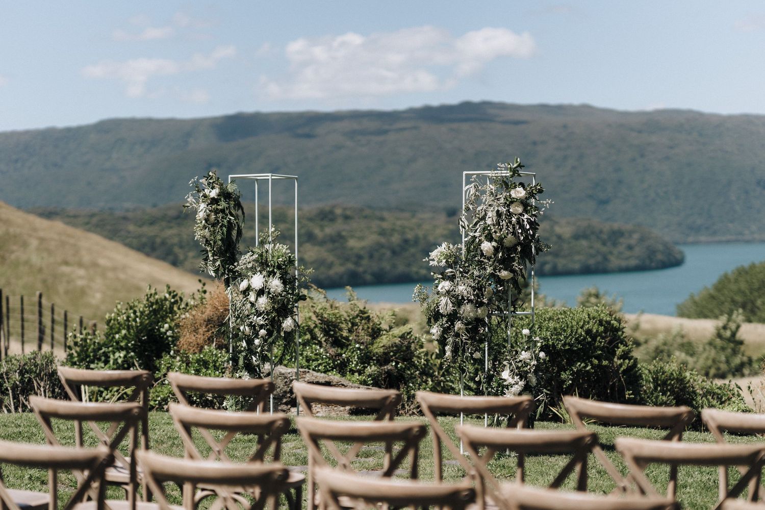 Elegant outdoor wedding reception setup overlooking a scenic mountain lake view.