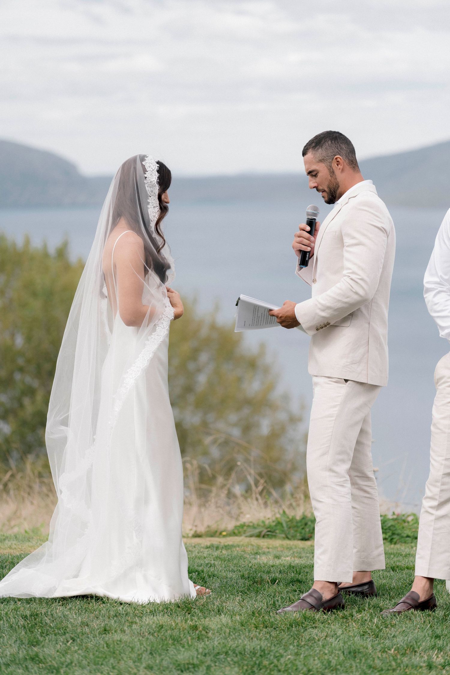 Wedding ceremony on a hilltop overlooking mountain views.