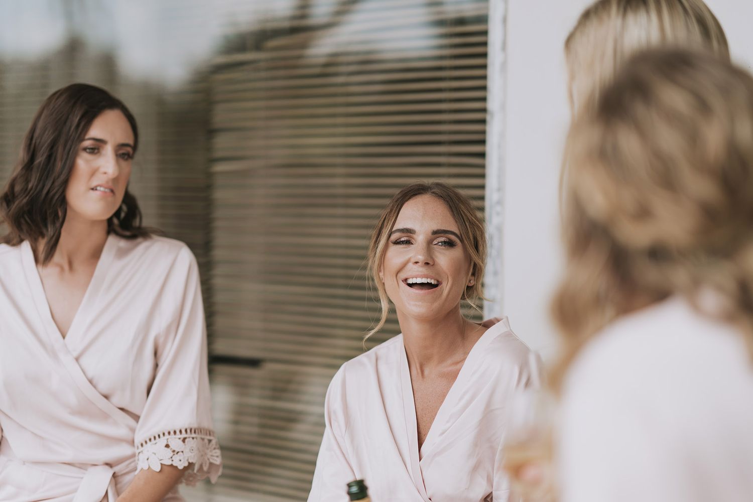 A collection of candid bridal preparation shots showing people getting ready in soft natural lighting.