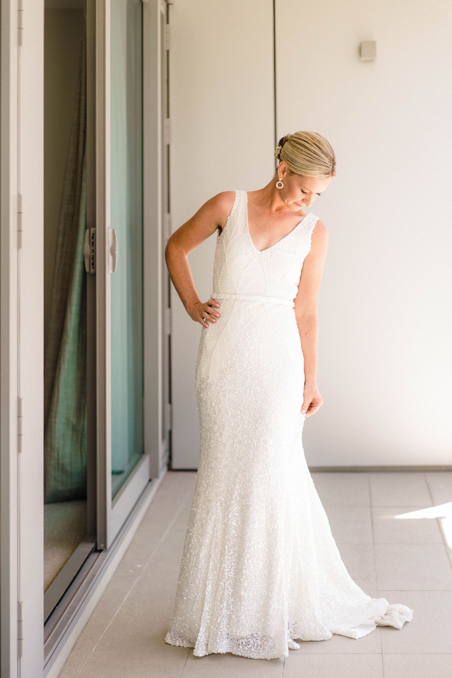 White lace wedding dress showcased in a bright indoor setting with multiple detail shots.