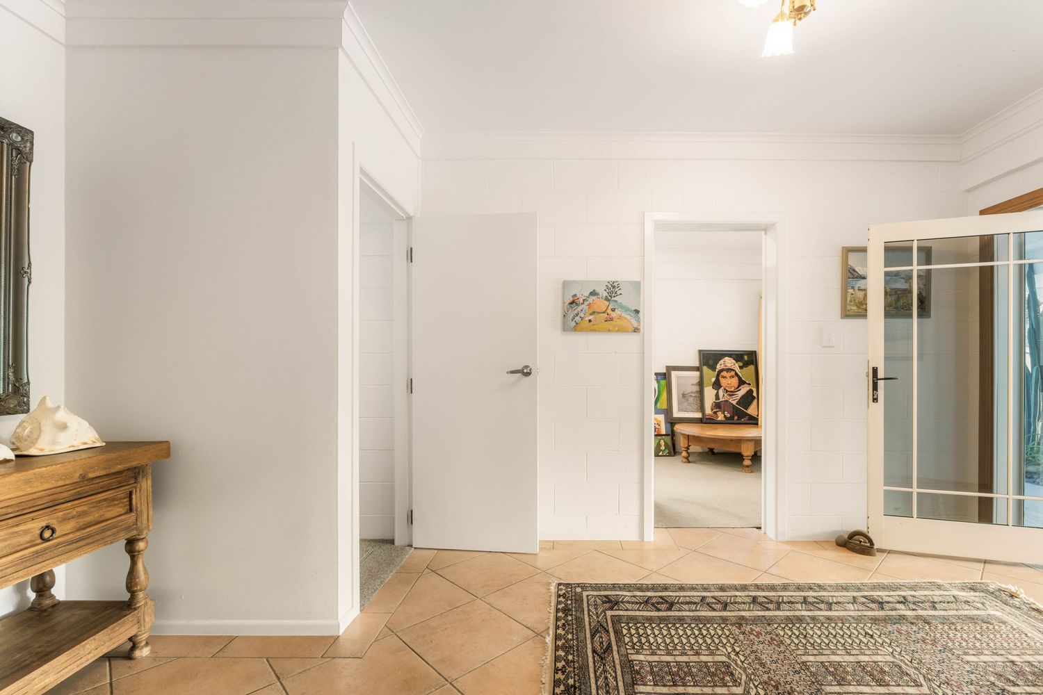 Clean white interior room with crown molding and recessed lighting displaying modern minimalist design.