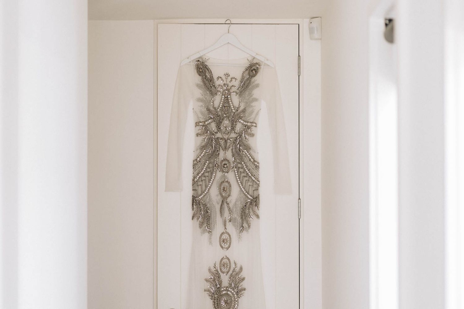 Three abstract black and white botanical prints in matching white frames displayed on a light neutral wall.