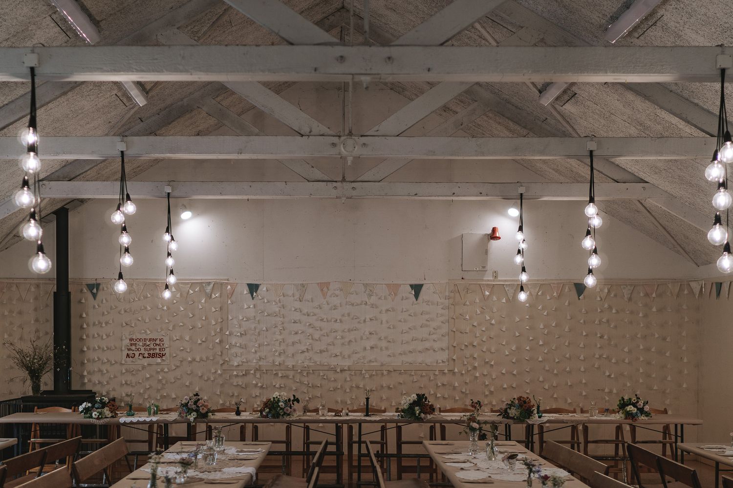 Interior view of modern industrial warehouse space with exposed ceiling beams, track lighting and polished concrete floors.