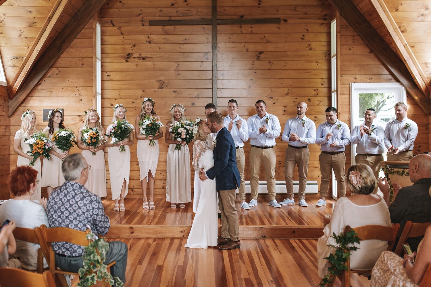 Rustic wooden barn wedding ceremony venue showcases elegant design with exposed beams and natural lighting.