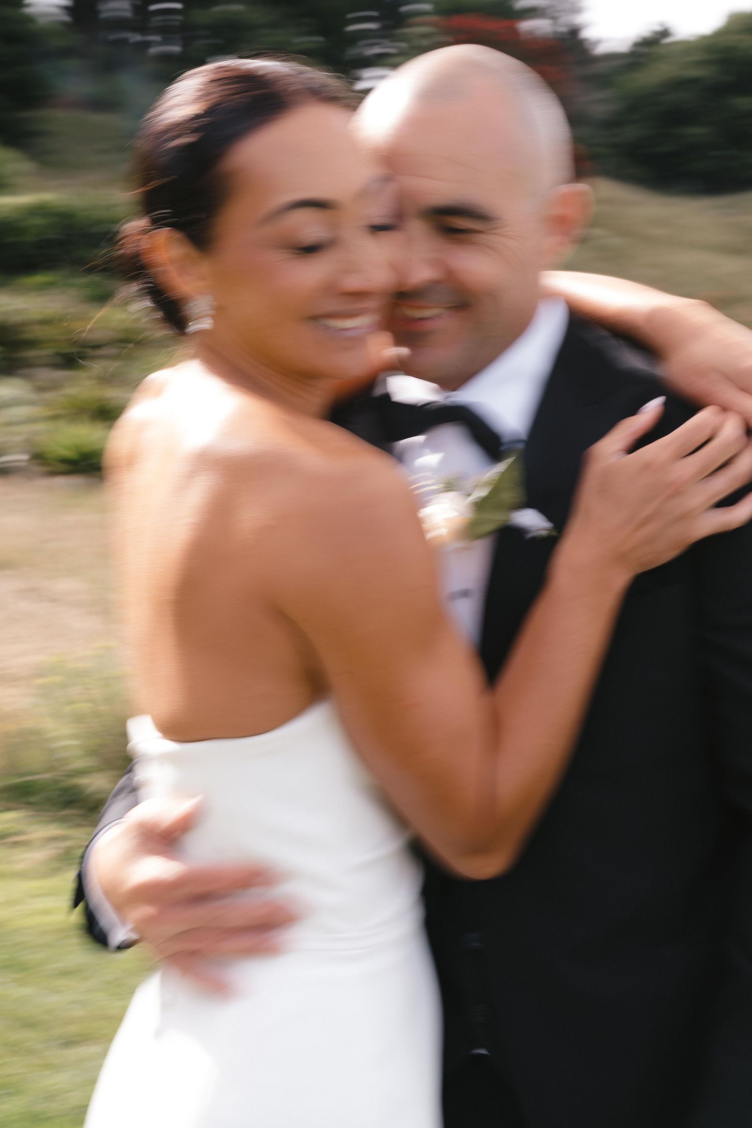 Candid moments of joy between newlyweds during outdoor photo session.