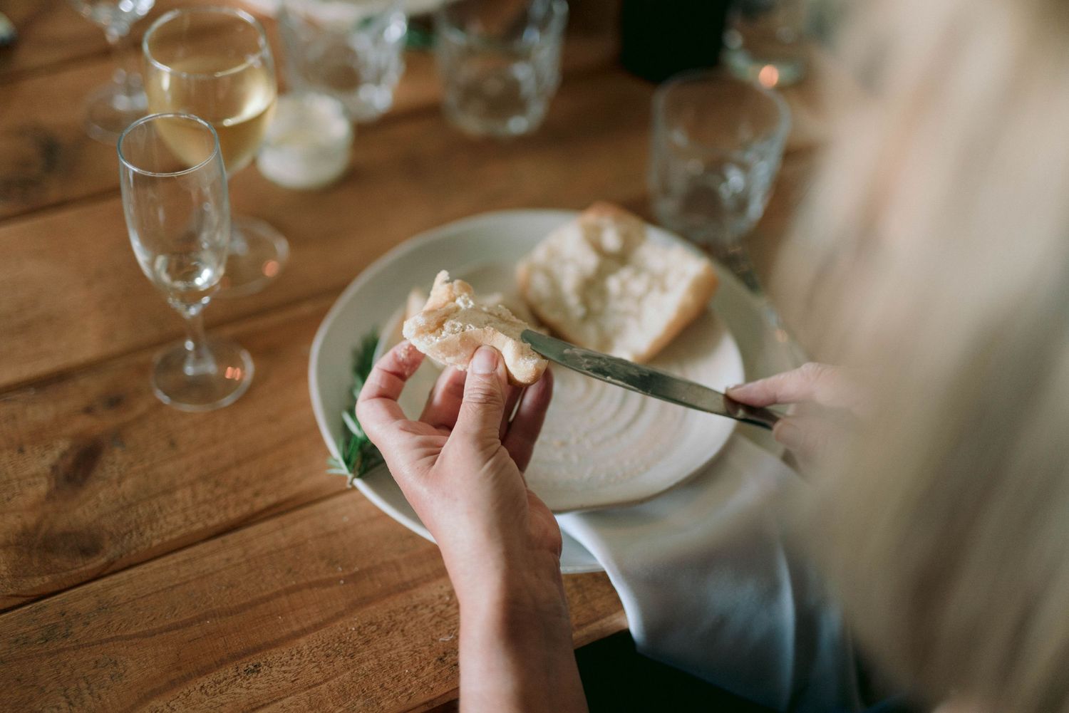 Close-up details of place settings and glassware at a rustic wedding reception.