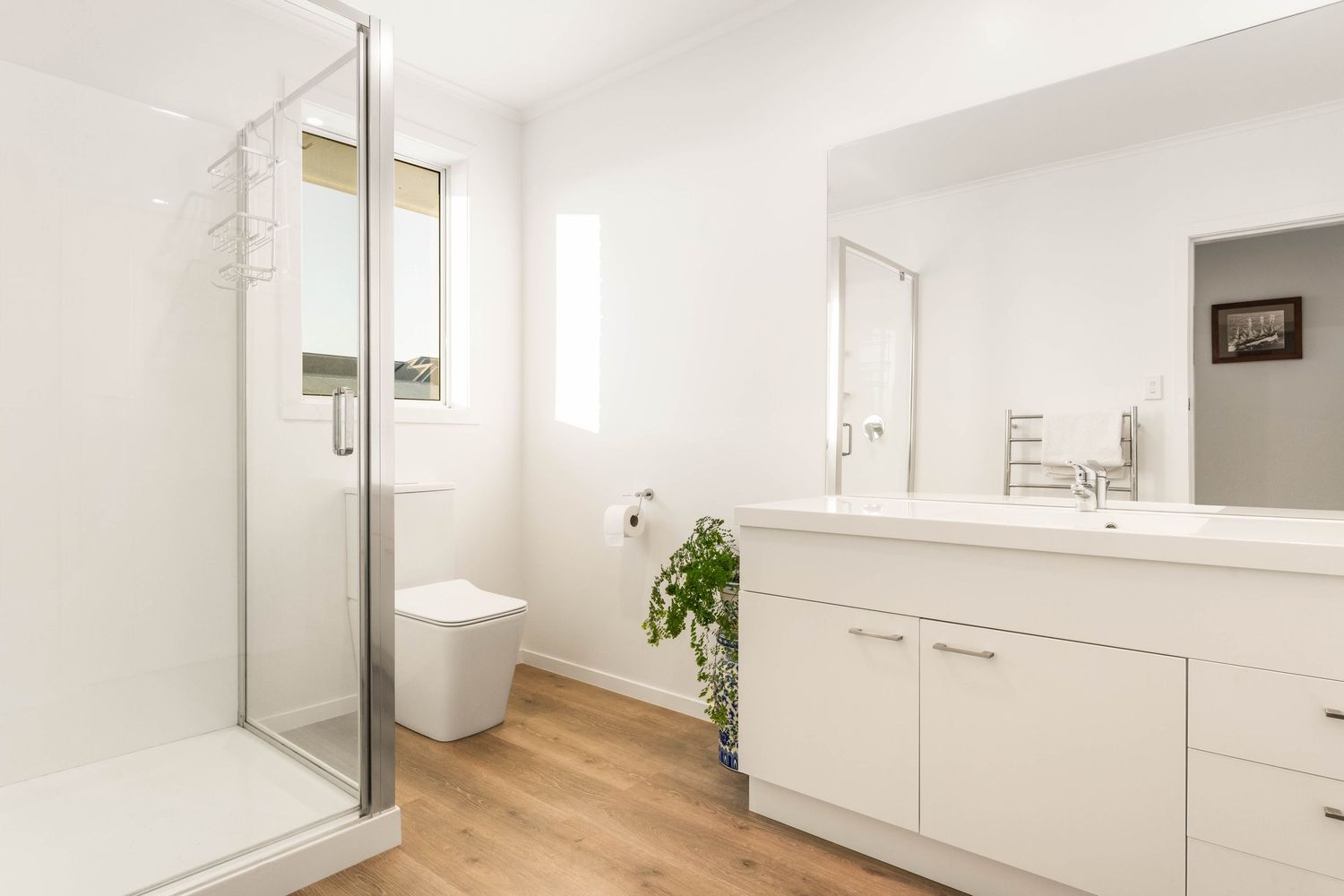 Minimalist white interior hallway with wooden accents and modern fixtures creating a clean aesthetic.