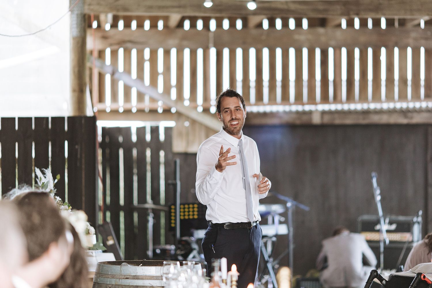 A rustic-style indoor venue with exposed beams and pendant lights creates an elegant dining atmosphere.
