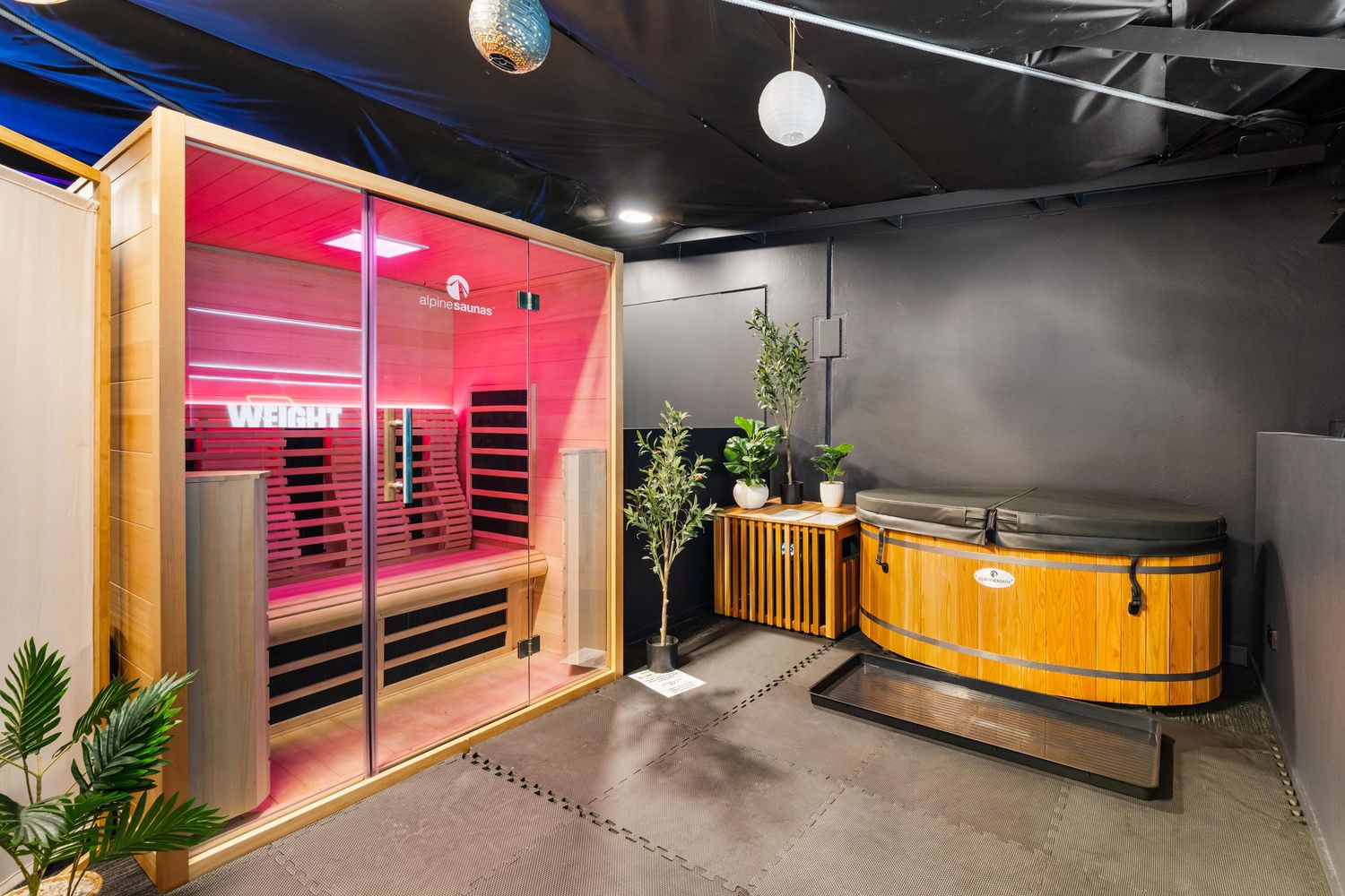 Industrial hallway interior with pink accent walls, wooden elements and modern lighting fixtures.