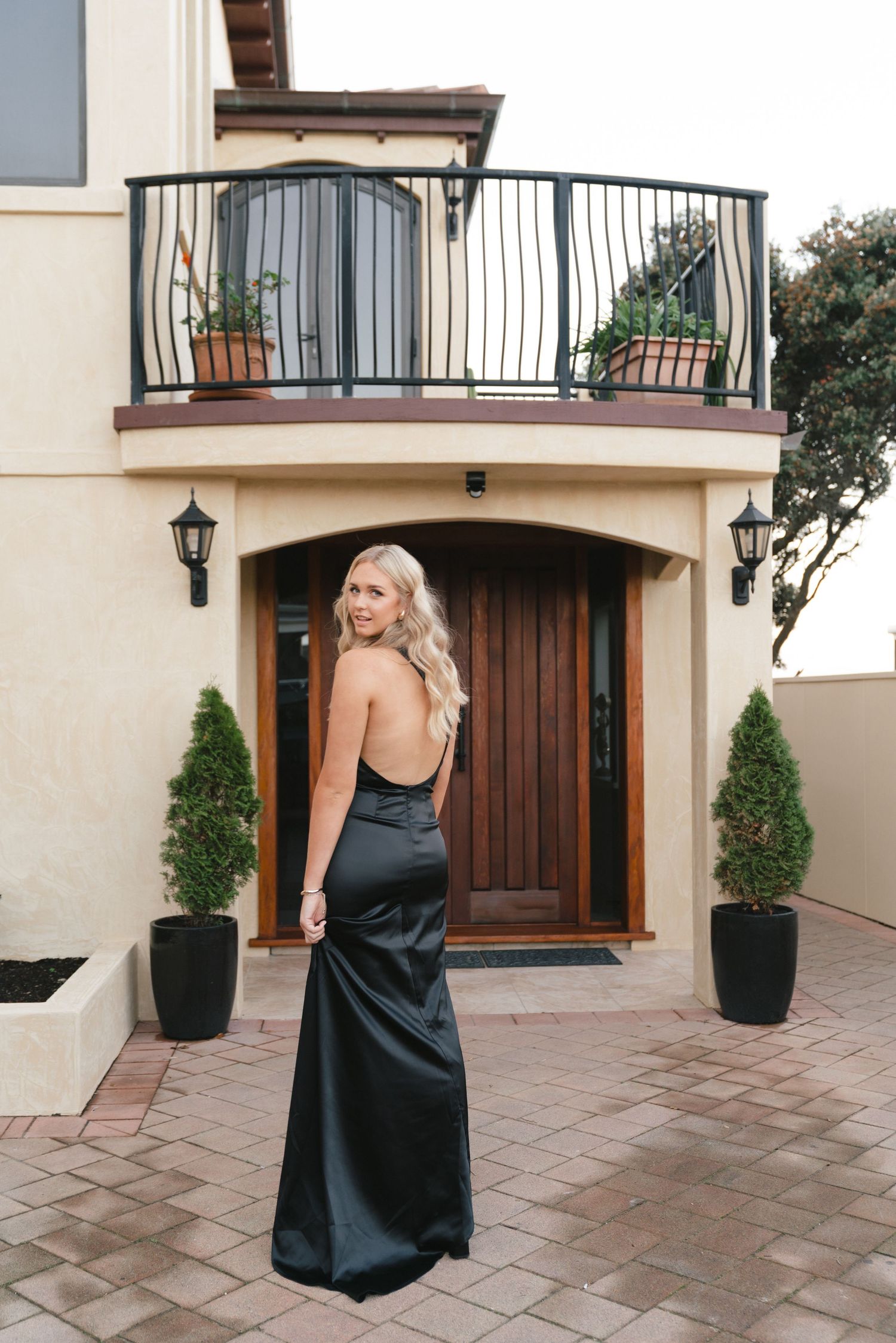 Mediterranean style courtyard with potted plants and arched doorways at luxury venue.