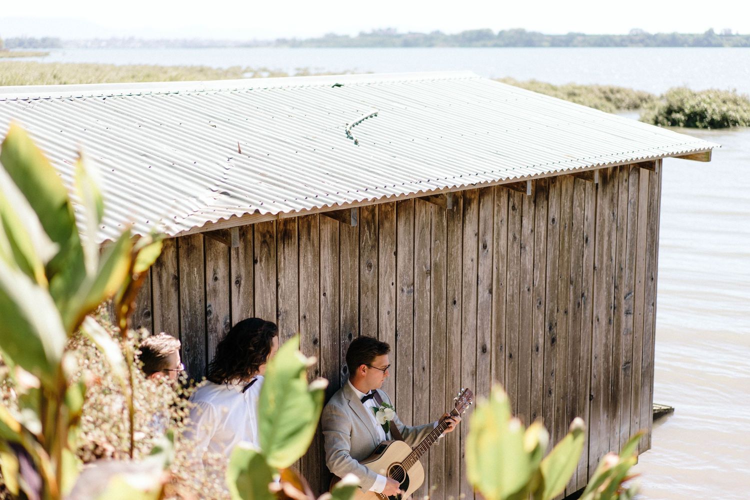 Rustic wooden structure overlooking a waterfront landscape.