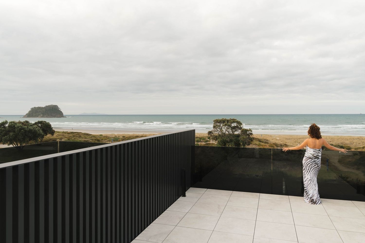 Expansive outdoor terrace with coastal views and modern architectural details.