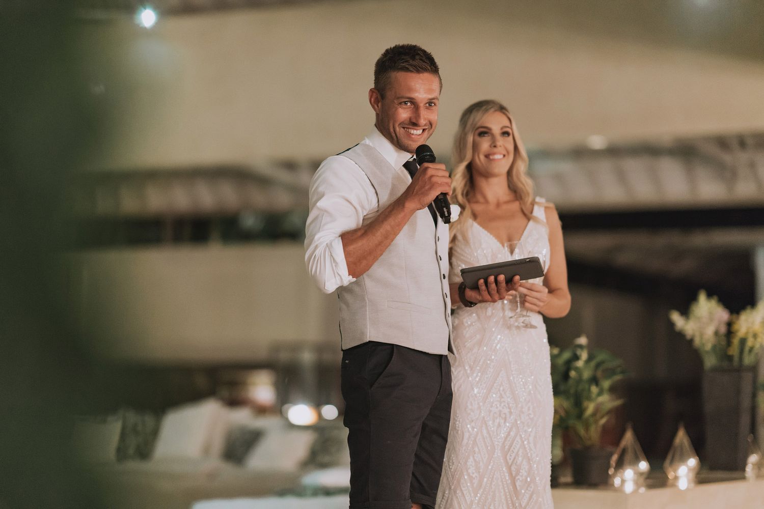 Evening wedding reception with warm lighting and celebratory atmosphere.