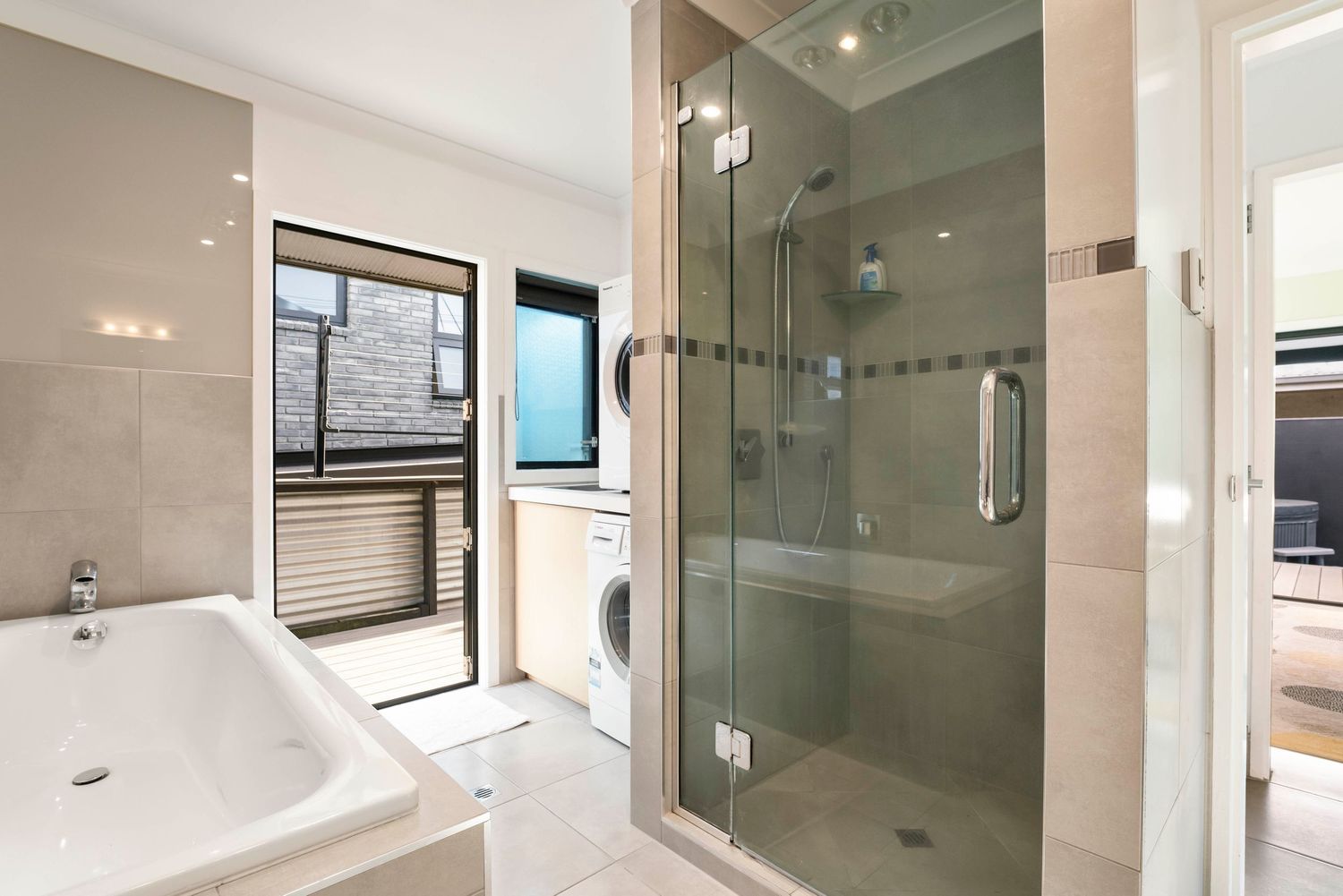 Luxurious bathroom featuring frameless glass shower enclosure and modern fixtures.