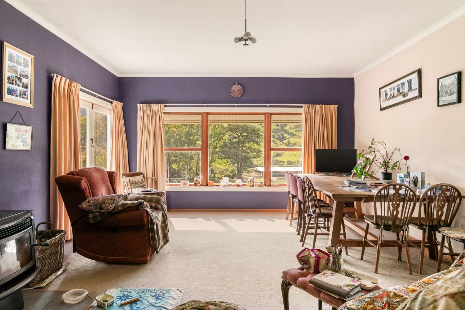 Spacious interior living room features window views of surrounding countryside and comfortable furnishings.