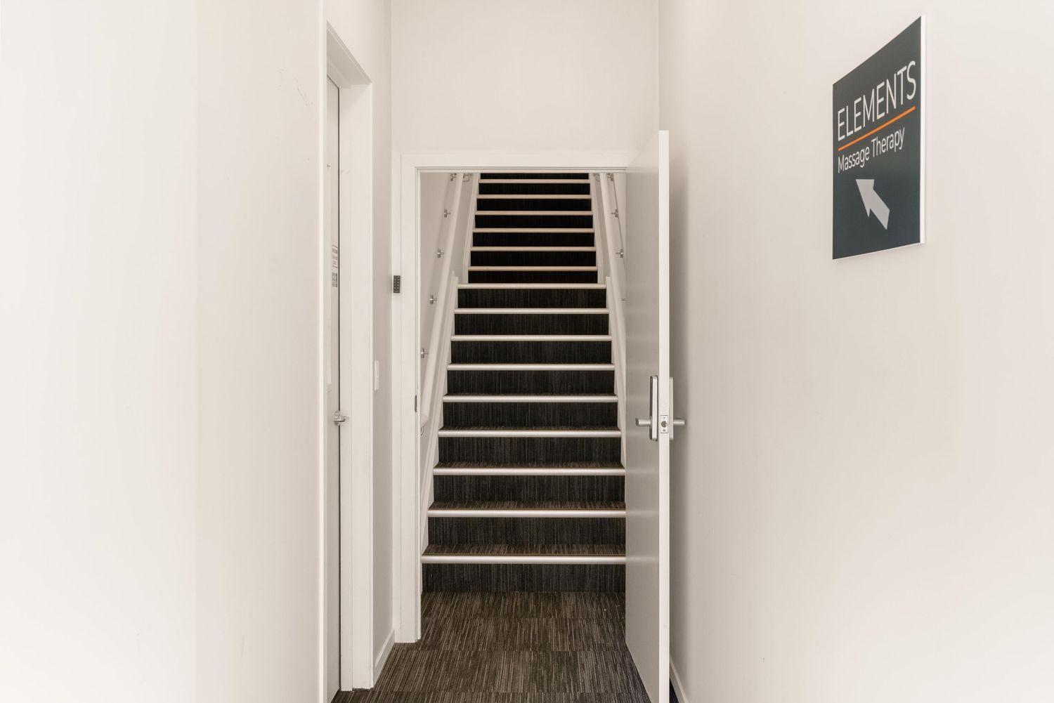 Modern black and white staircase with minimalist design leading upwards.