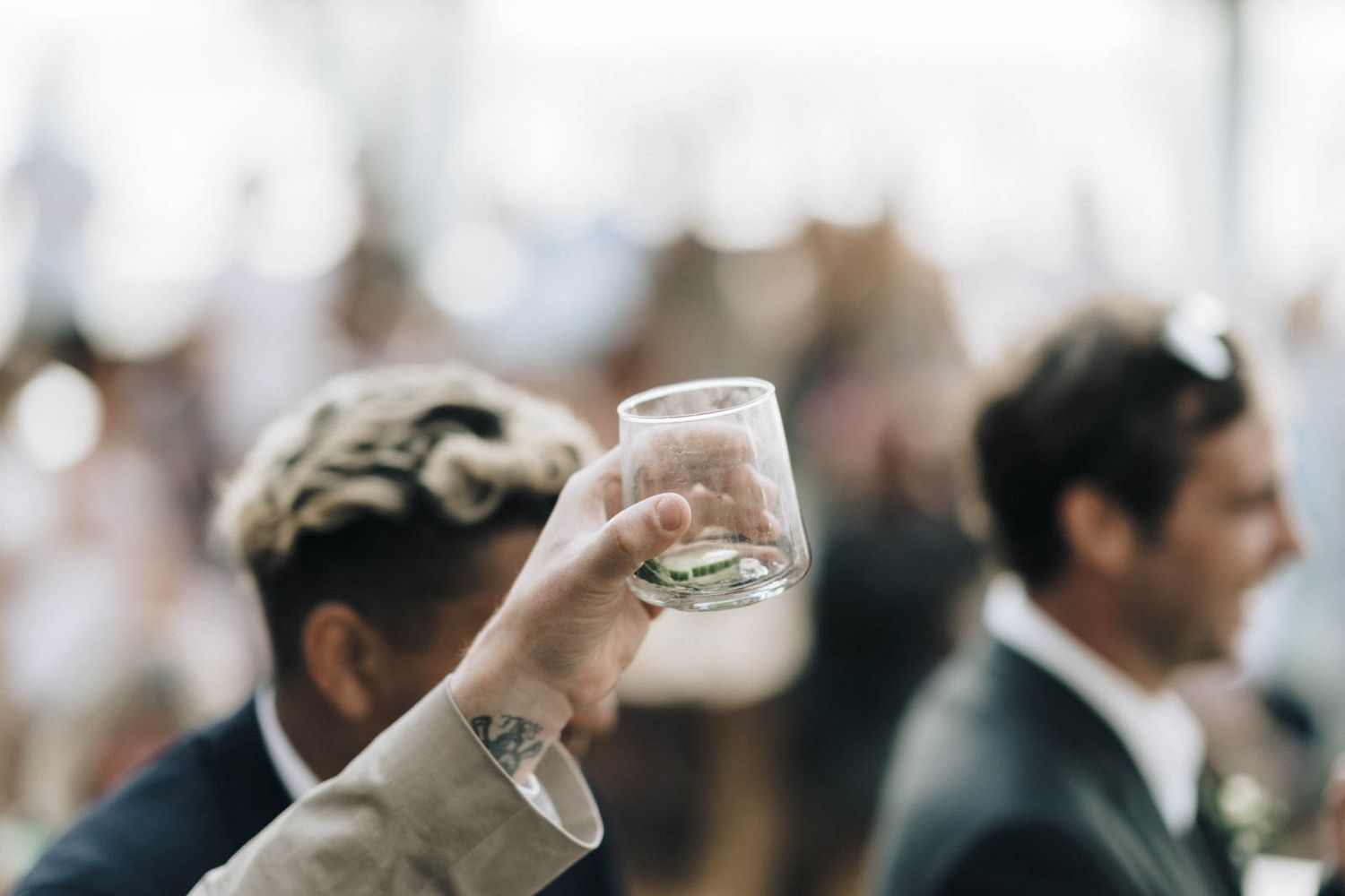 People at a social gathering hold beverages while mingling and networking at an elegant event.