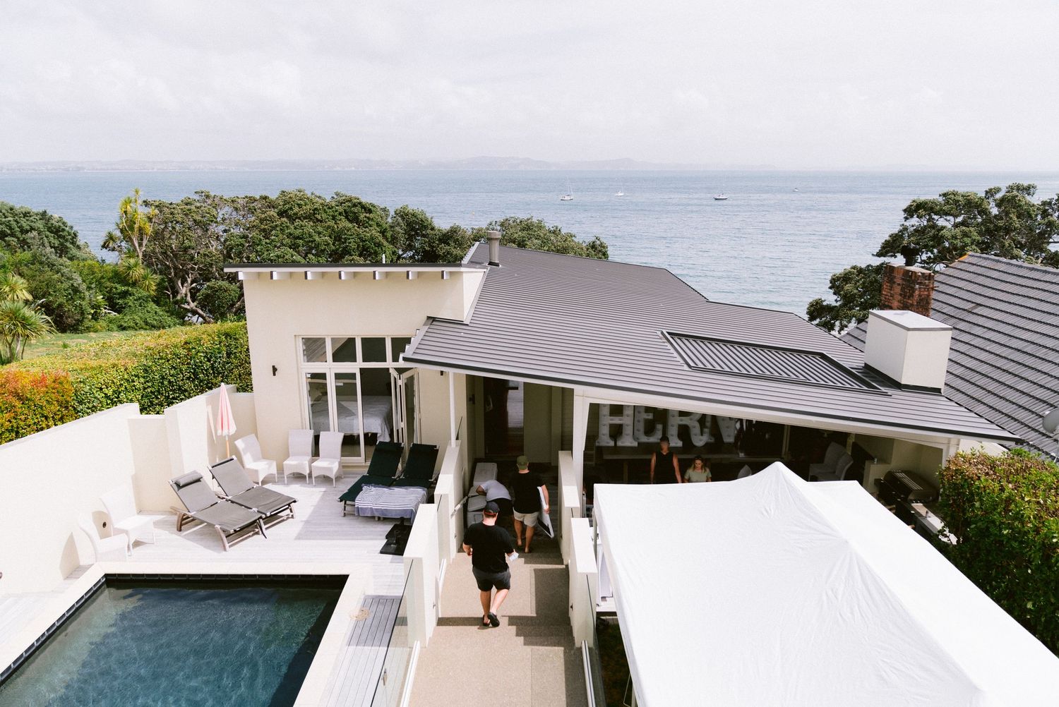 Modern beachfront villa with infinity pool and ocean views showcases sleek contemporary architecture and landscaping.