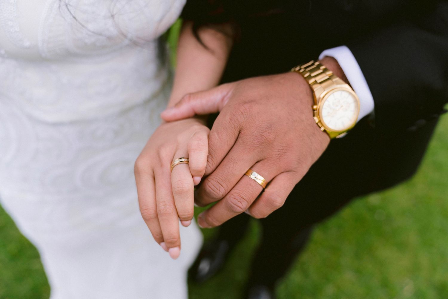 Close-up shots of wedding rings and hands showing newly married couple's wedding bands.