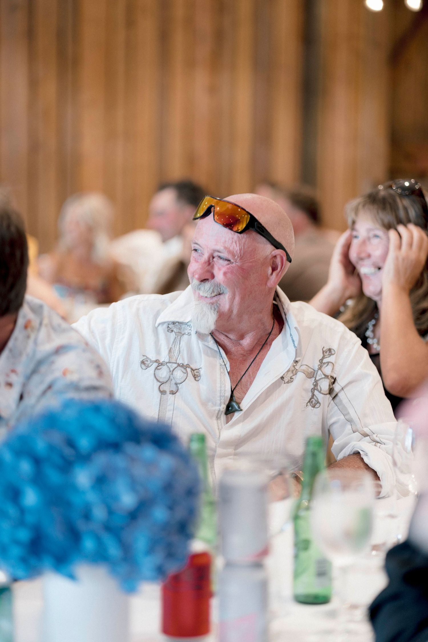 Guest enjoying reception dinner in casual attire with festive table decorations.