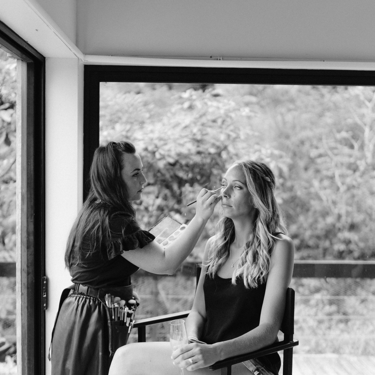 Two people dancing together in a black and white photo while sharing a joyful moment.