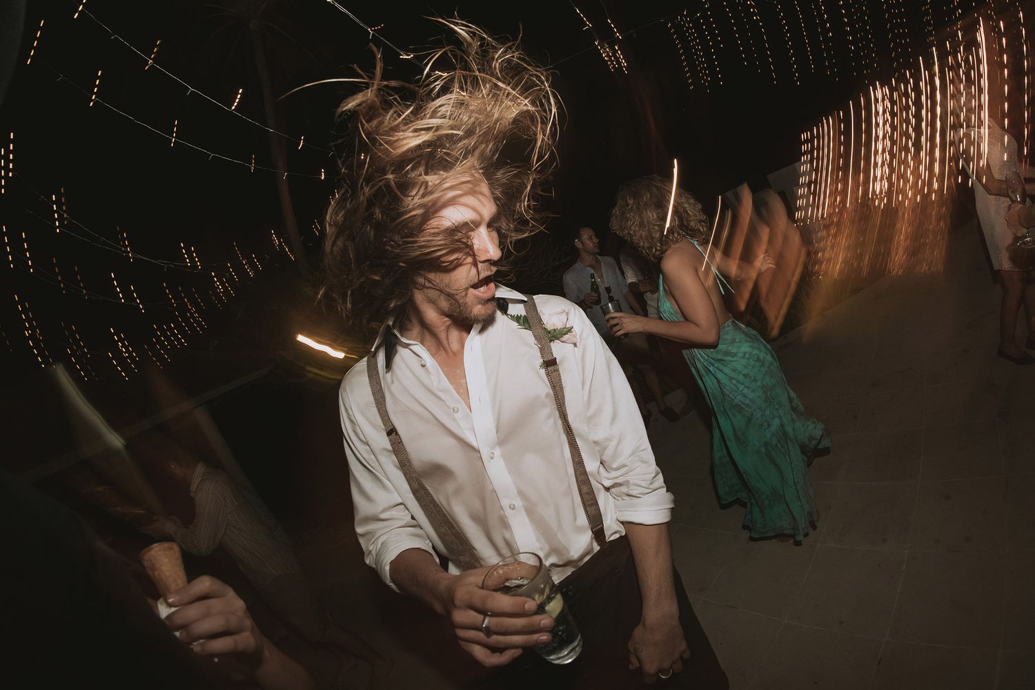 Dynamic party photo capturing movement and energy on a dimly lit dance floor.