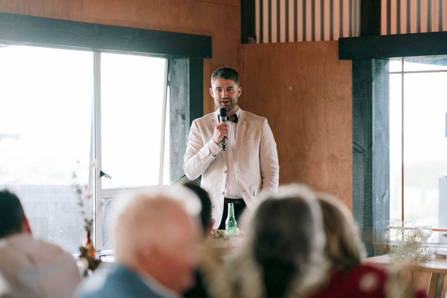 A wedding guest delivers a heartfelt speech during the reception celebrations.