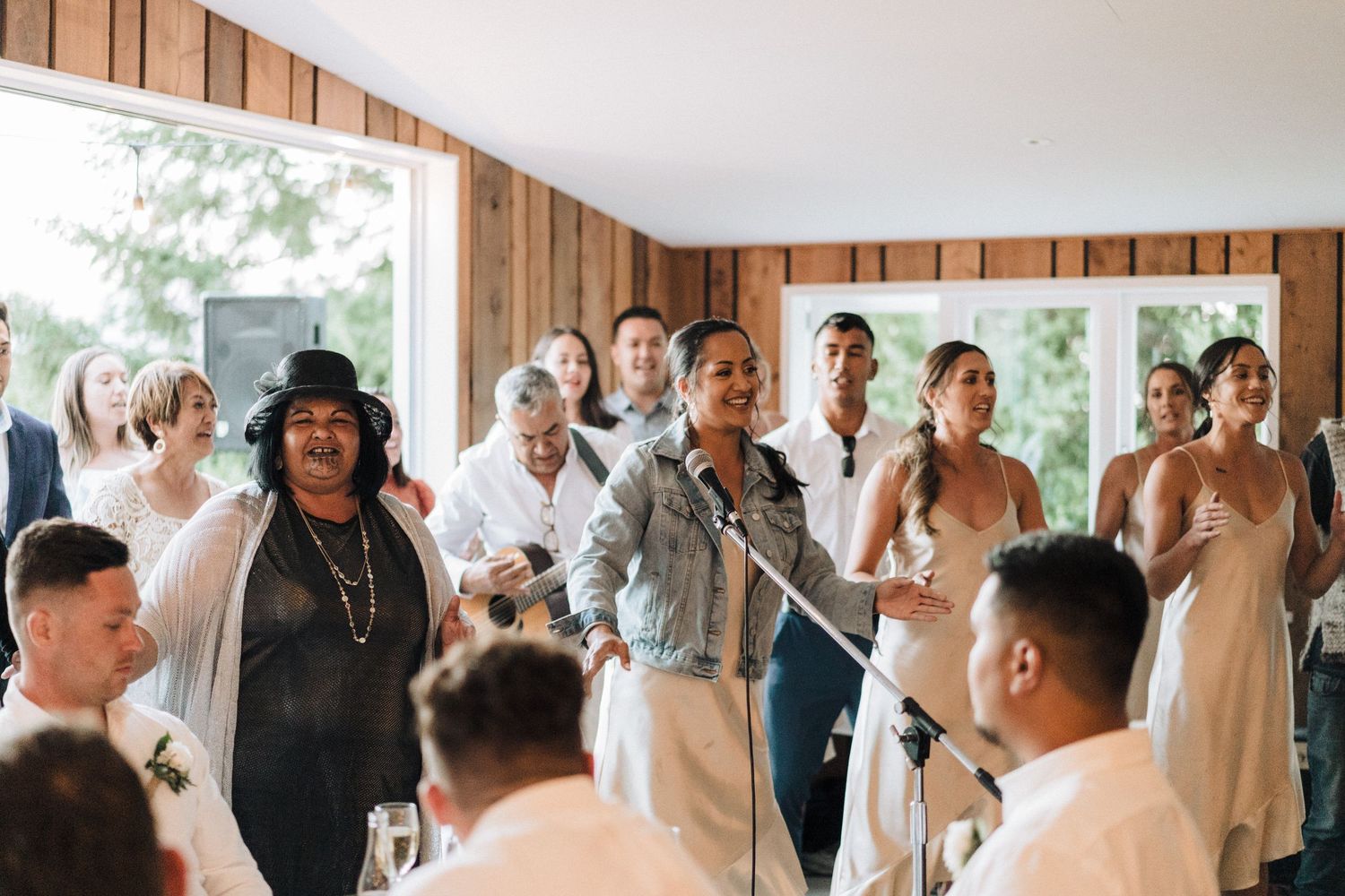 Wedding reception celebration with guests dancing and enjoying themselves indoors.