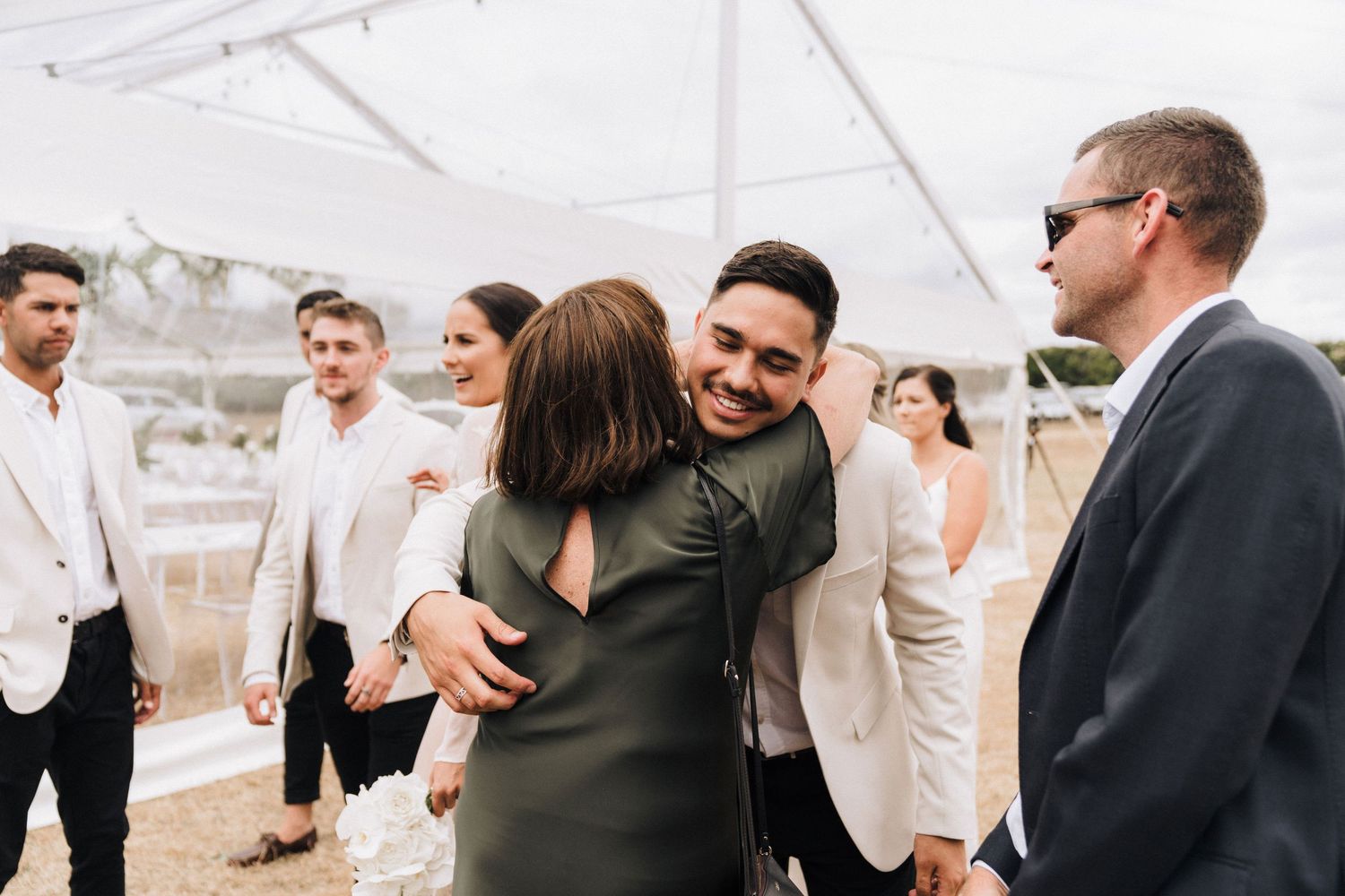 Wedding guests mingling at an outdoor reception.