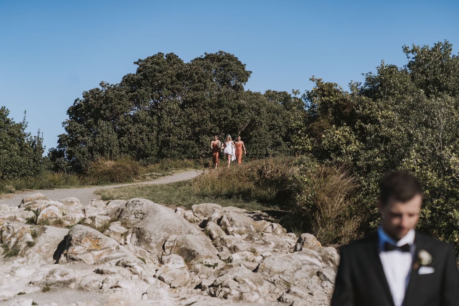 A scenic rocky outcrop with trees in the background during a wedding photoshoot.
