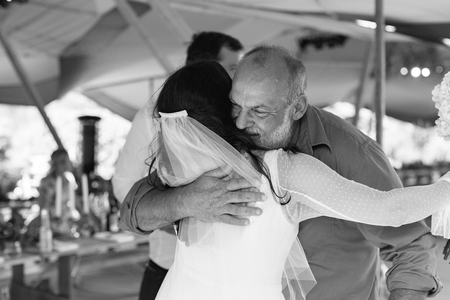 People celebrate and dance together at a lively swing dance event in black and white photography.