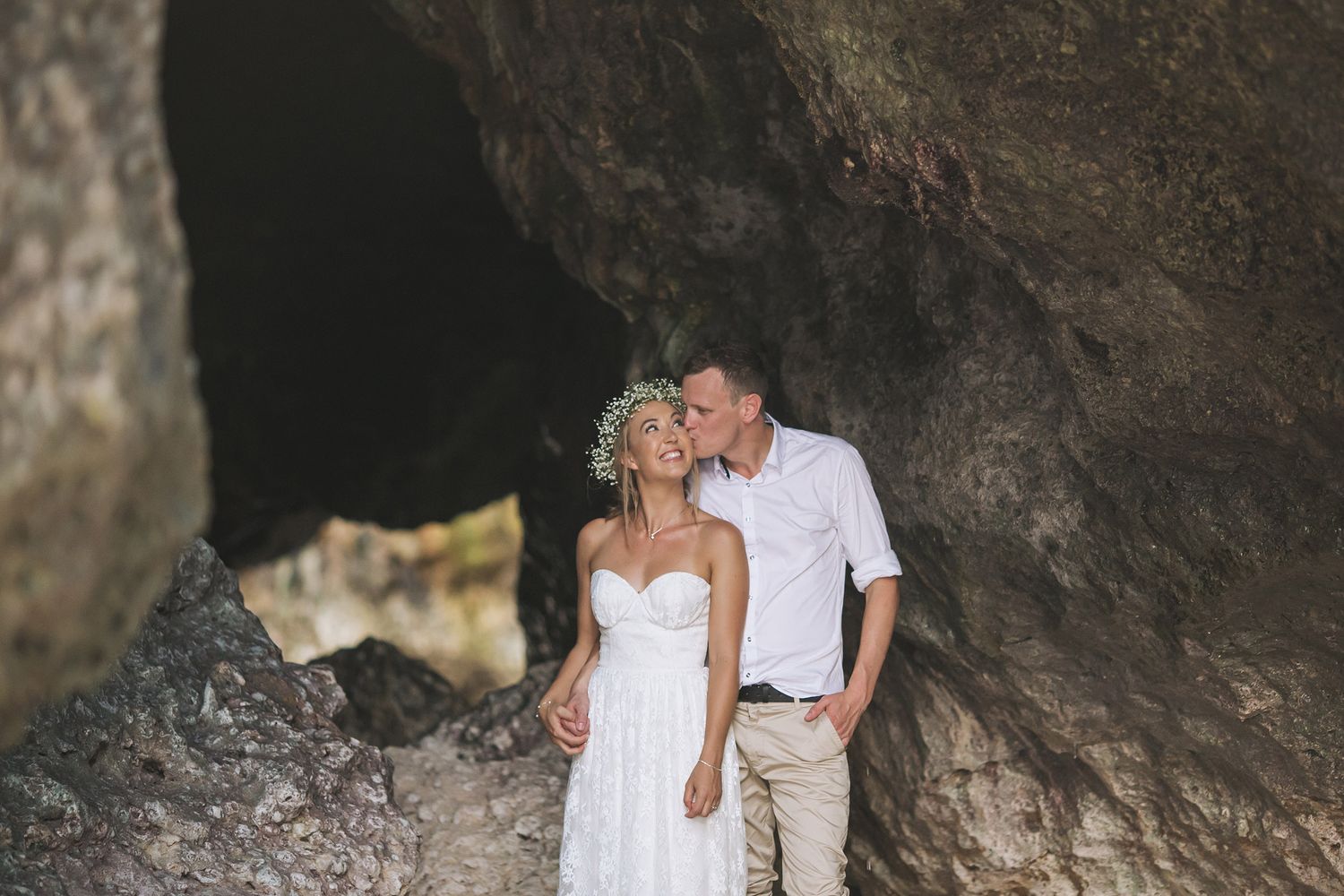 A romantic couple photo session in a dramatic cave setting.