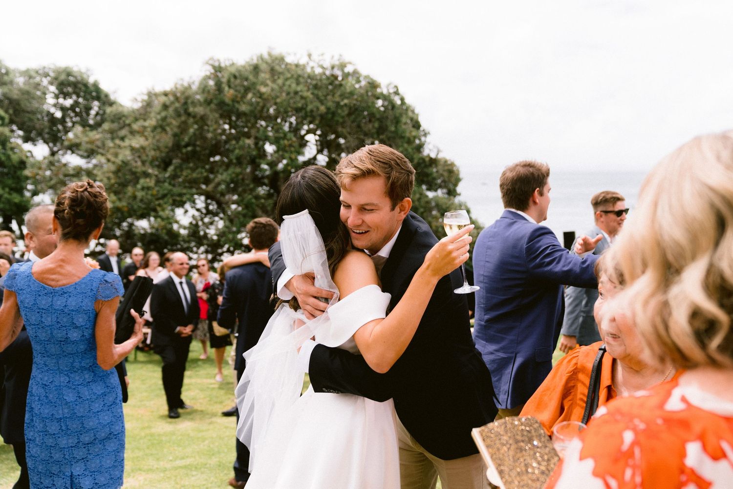 Wedding guests celebrating during the reception outdoors.