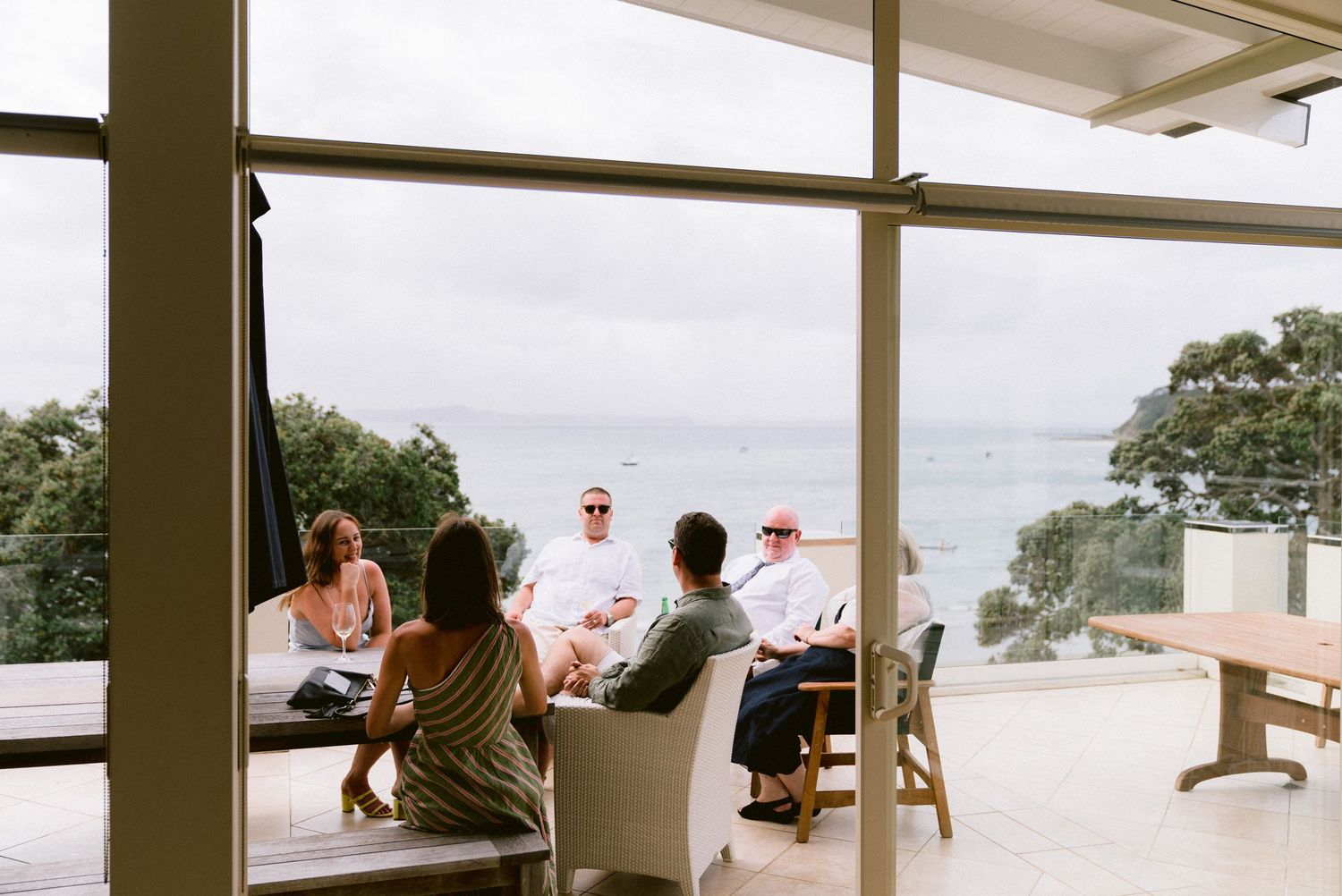 Modern indoor venue with panoramic windows overlooking scenic coastal views.