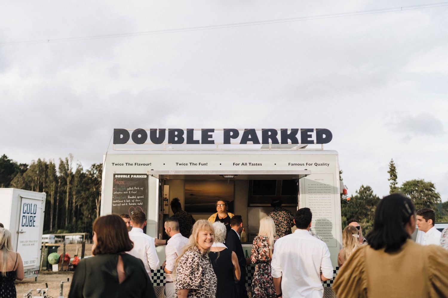 Mobile retail trailer 'Double Parked' stationed at an outdoor event venue.