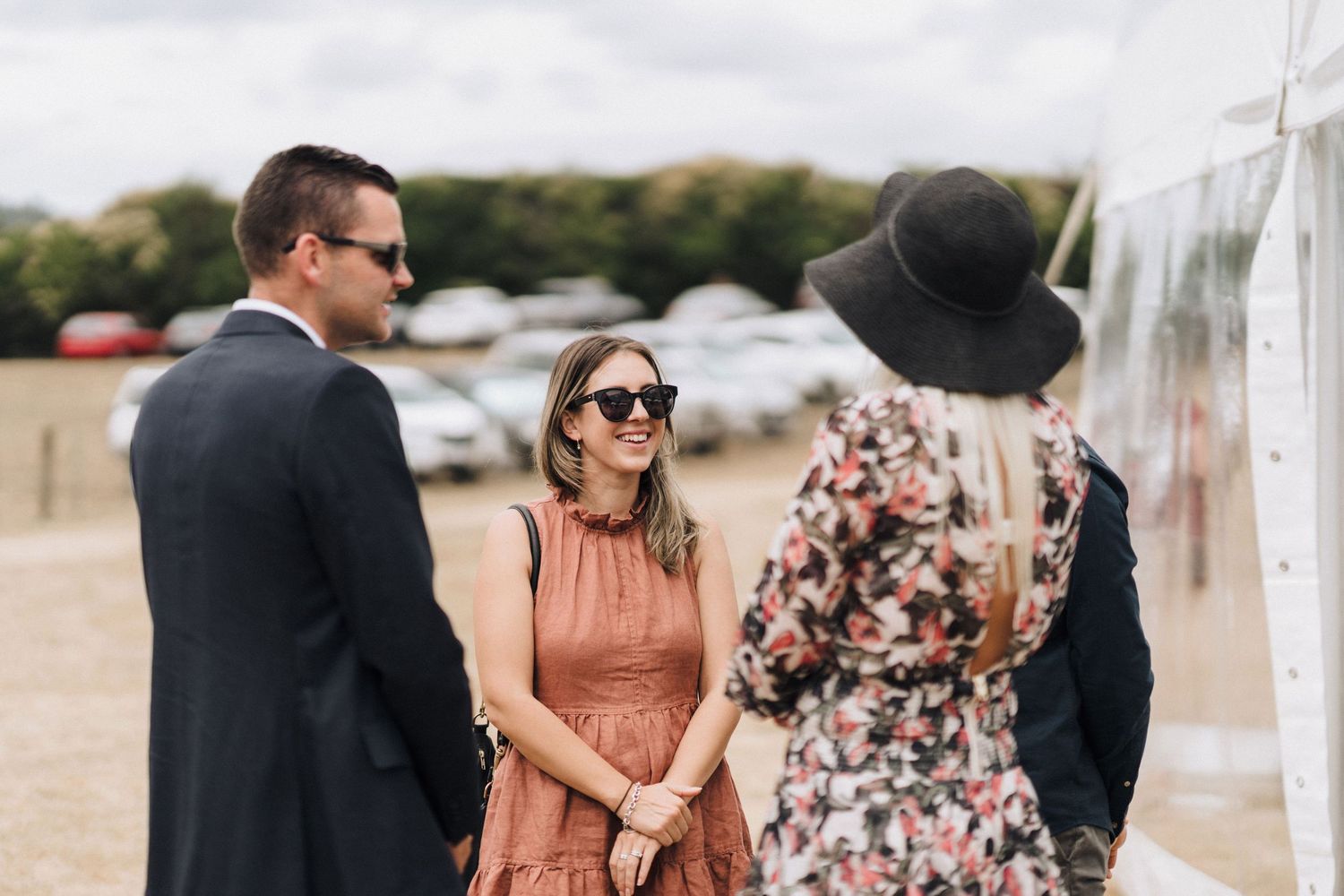 Wedding guests enjoying an outdoor celebration in summer attire.