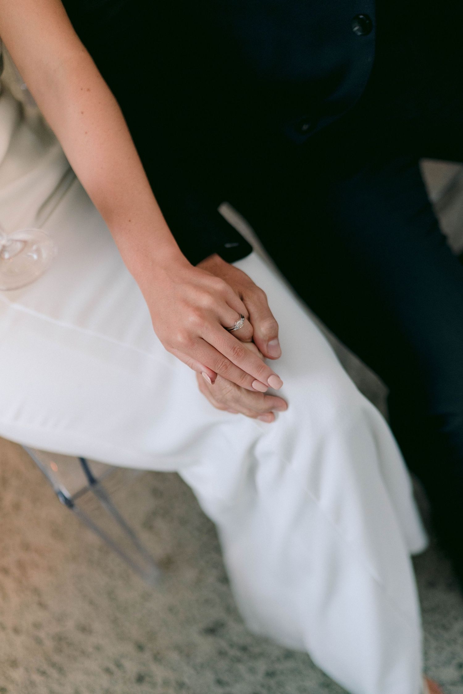 Close-up shot of hands smoothing white fabric texture.