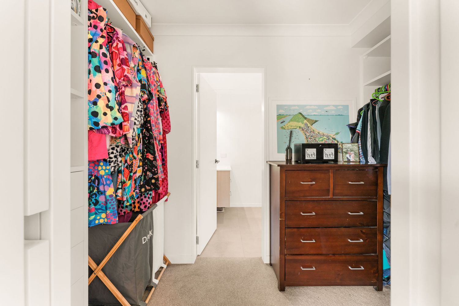 Long hallway with white walls, wooden doors, and built-in storage closets showcasing modern home interior design.