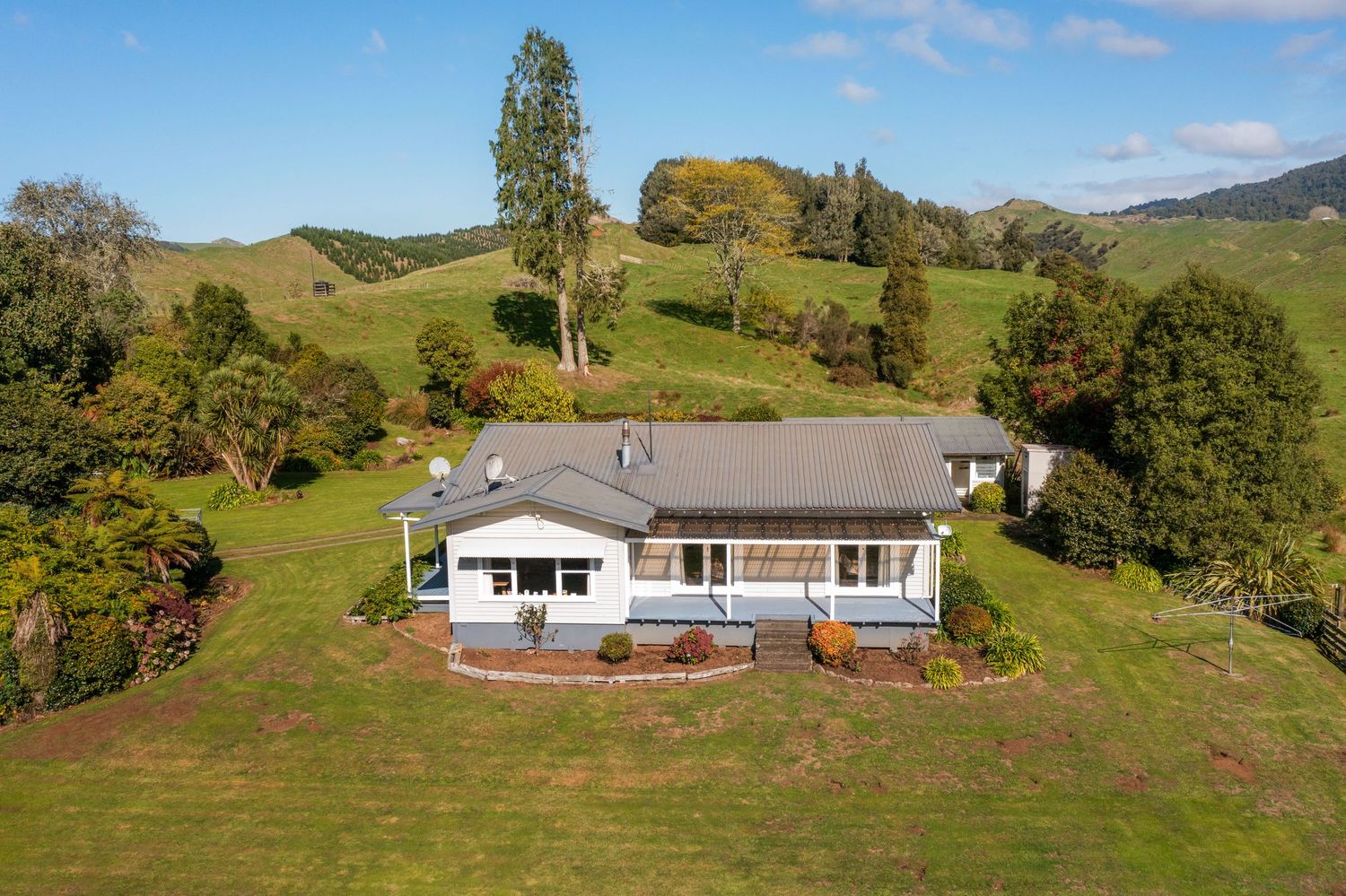 Modern ranch-style homes situated on expansive hillside property with mountain views.